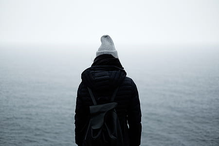 person standing infront of body of water thumbnail