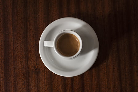 coffee cup filled with coffee on table thumbnail