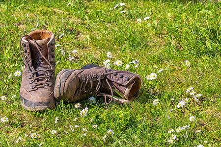 pair of brown leather boots on green grass field thumbnail