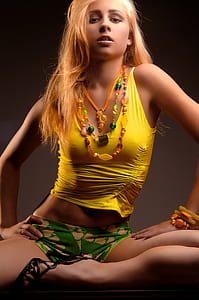 woman sitting on chair wearing yellow tank top thumbnail