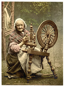 woman sitting on chair holding spinning wheel thumbnail