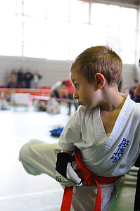 boy wearing martial arts gi kicking side thumbnail