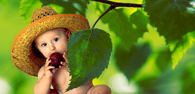 baby wearing straw hat eating fruit thumbnail
