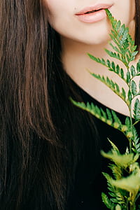 close-up photo of woman biting plant thumbnail