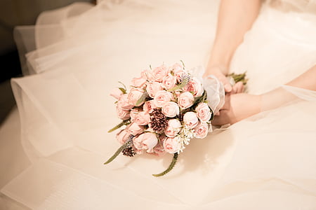 woman wearing wedding dress holding pink rose bouquet thumbnail