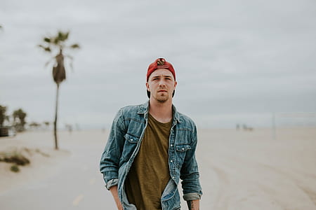 man in blue denim jacket during daytime thumbnail