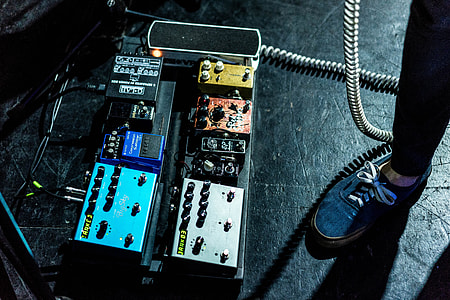person standing near guitar pedal devices thumbnail
