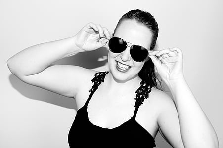 grayscale photo of smiling woman wearing camisole and sunglasses thumbnail