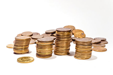 gold-colored coins stacked thumbnail