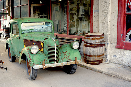 classic green vehicle parked beside building at daytime thumbnail