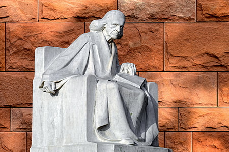 statue of woman holding book thumbnail