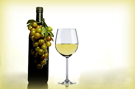 Wine in Wine Glass Near Green Glass Bottle thumbnail