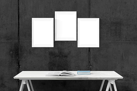 three rectangular white photo frames and white wooden table thumbnail