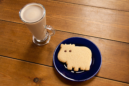 baked pastry on blue plate beside glass of brown liquid thumbnail