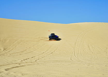 blue and gray monster truck on desert thumbnail