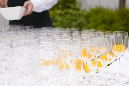 pile of clear champagne glasses near plants thumbnail