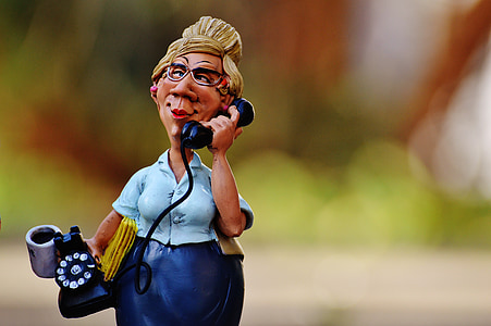woman holding rotary telephone figurine thumbnail