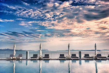 sun loungers near swimming pool thumbnail