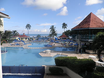assorted loungers and parasol beside pool thumbnail
