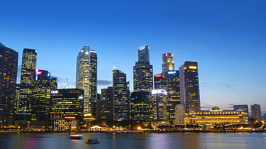 tall buildings beside body of water under blue sky during daytime thumbnail