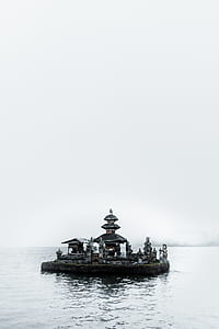 black floating island on body of water thumbnail