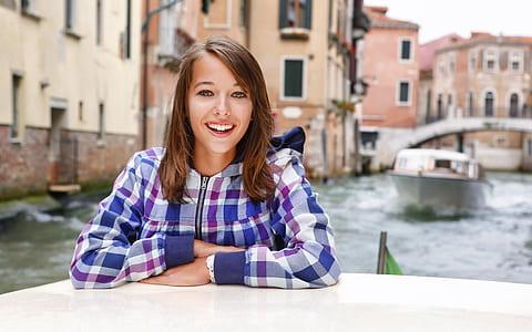 woman in blue and white plaid dress shirt in shallow focus photography thumbnail