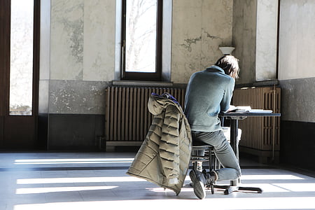 person sitting at the table inside room thumbnail