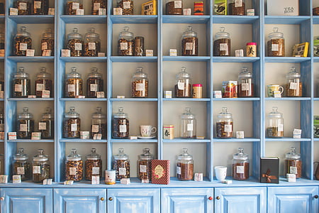 clear glass jars on blue wooden shelves thumbnail