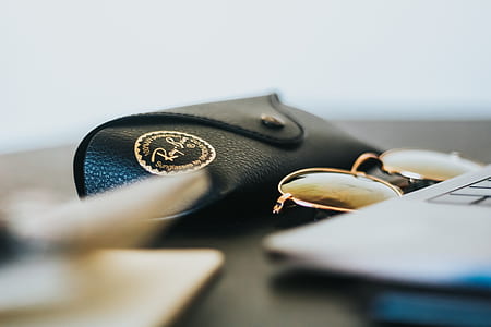 Ray-Ban sunglasses beside laptop computer thumbnail