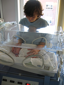 woman touching her newborn baby thumbnail