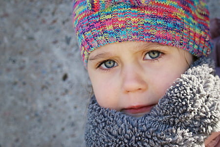 closeup photo of child in gray scarf thumbnail