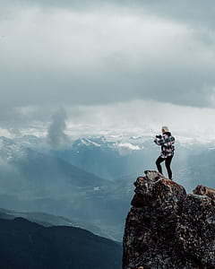 person on top of the mountain overlooking the mountains thumbnail