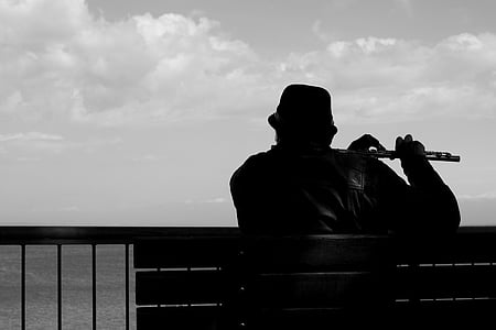 silhouette of man playing flute thumbnail