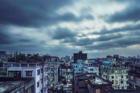aerial photography on concrete buildings under cloudy sky thumbnail