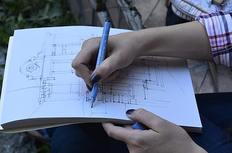 person sketching house thumbnail