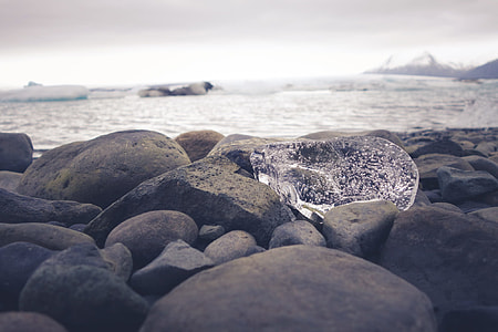 black rock lot near body of water thumbnail