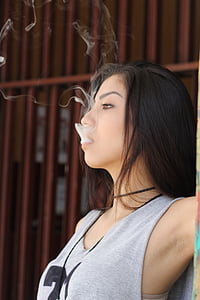 woman smoking near grill screen thumbnail