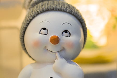 white and orange thinking baby snowman ceramic figurine thumbnail
