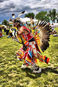 male native American dancing on grass field thumbnail
