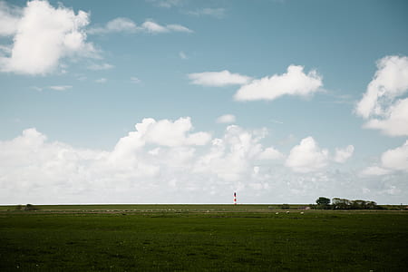 landscape photo of tower on field of grass thumbnail