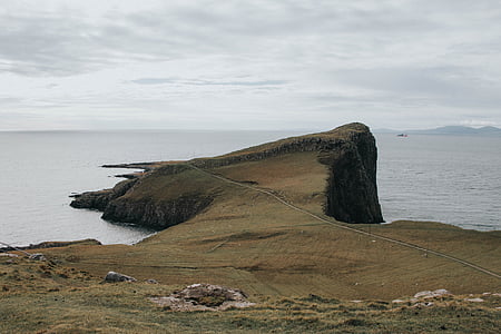 brown cliff near body of water thumbnail