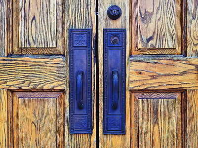 brown wooden doors with two blue metal door handles thumbnail