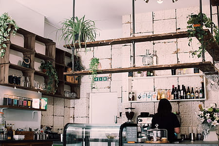 Woman Beside Bottles and Cupboard thumbnail