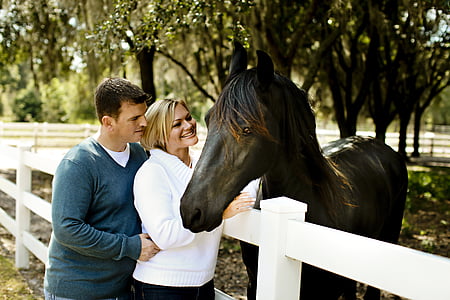man and woman standing in front of horse thumbnail