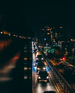 photo of vehicles on road near high-rise building thumbnail