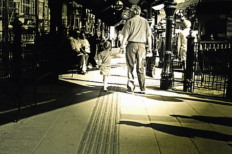 grayscale photography of man and child walking thumbnail