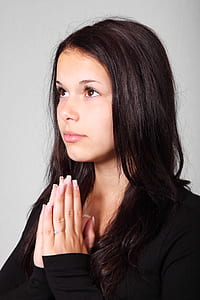 girl wearing black long-sleeved shirt praying thumbnail