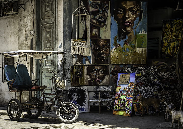 black bicycle near paintings