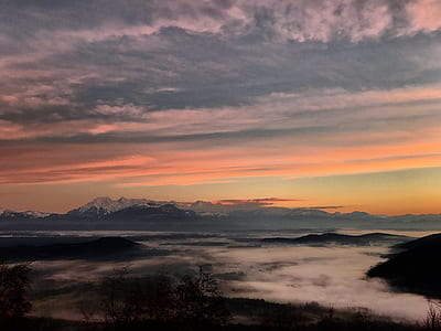mountains under gray clouds during sunset thumbnail
