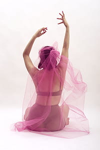 woman wearing pink mesh veil sitting on white floor thumbnail